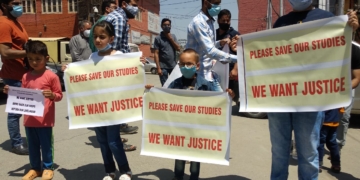 Shopkeepers protest along with their children after their shops handed over to ex-service men