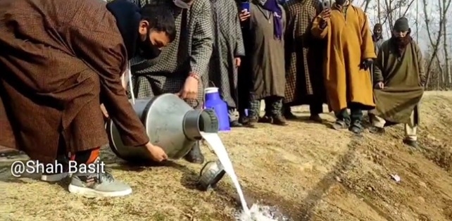 Dairy farmers empty milk canes on the ground after finding no consumers in Central Kashmir’s Ganderbal